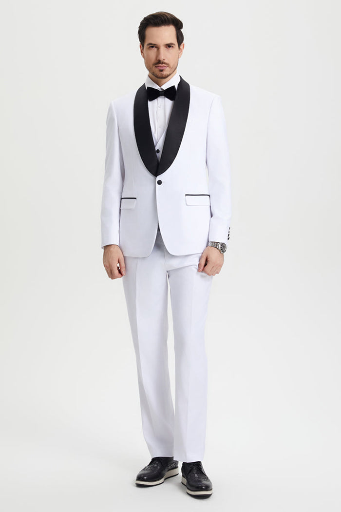 White Stacy Adams one-button tuxedo with black satin shawl lapel. Fitted, smooth fabric. Includes matching trousers, minimal black detailing, white shirt, and black bow tie. Paired with black shoes.
