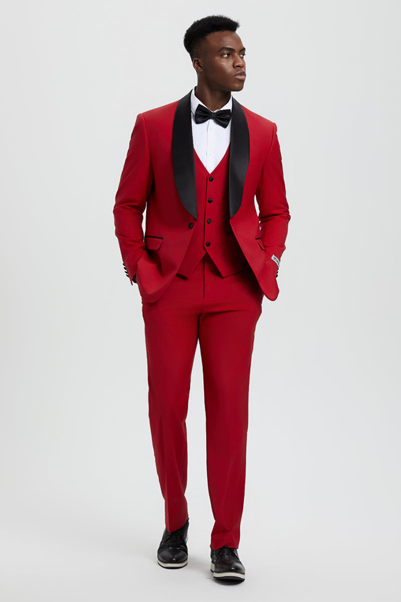 Red Stacy Adams tuxedo with shawl lapel. Single-button jacket, matching vest, and tailored trousers. Black lapel accents, paired with a white dress shirt for a formal look. Smooth, structured material.
