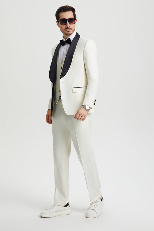 Ivory Stacy Adams tuxedo: one-button jacket with black shawl lapel, matching vest and pants. Includes shirt and bow tie. Tailored from smooth fabric.
