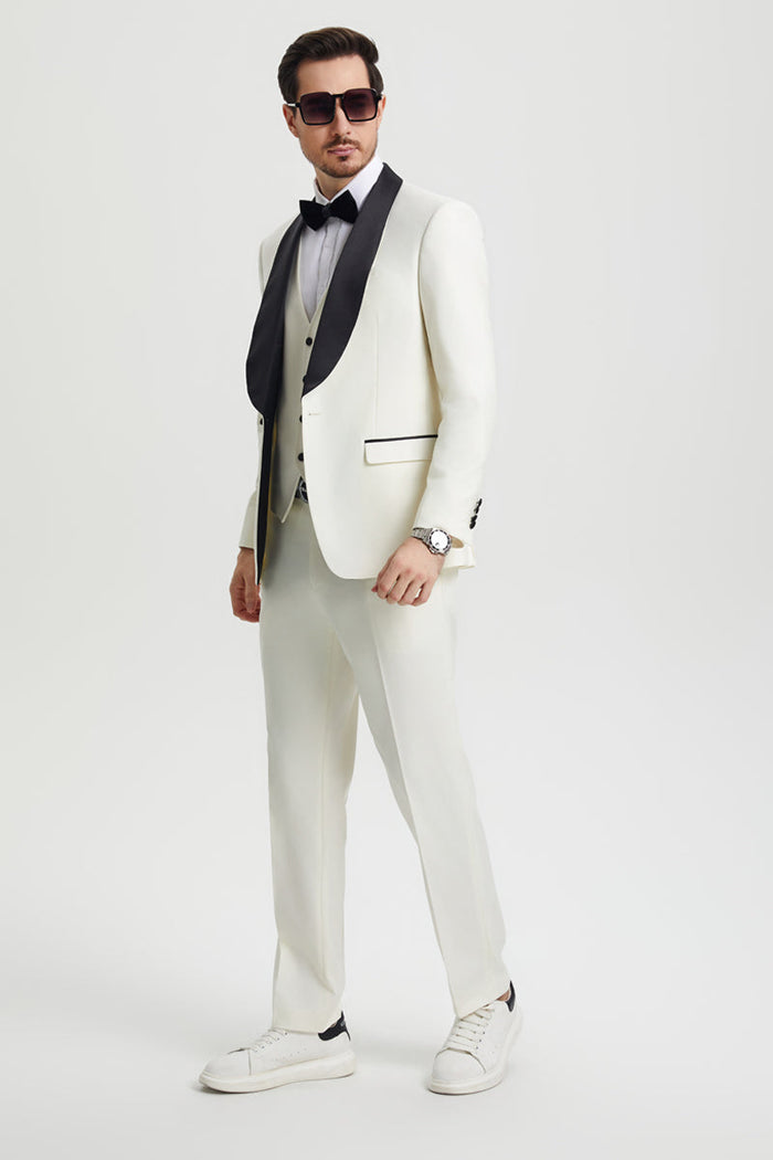 Ivory Stacy Adams tuxedo: one-button jacket with black shawl lapel, matching vest and pants. Includes shirt and bow tie. Tailored from smooth fabric.
