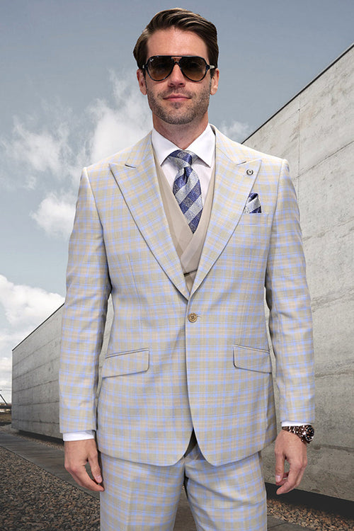 Men's one-button peak lapel wool vest suit in tan windowpane plaid. Light tan base with blue/white grid. Includes blazer, matching trousers, and solid tan vest. Wool blend fabric.
