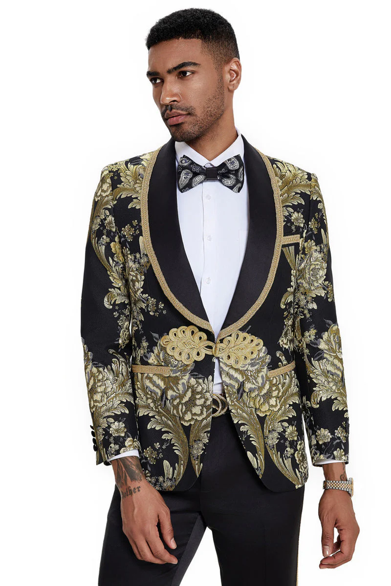 Men's black paisley tuxedo with gold floral accents. Single-button shawl lapel jacket features satin lapels and detailed button closures. A sophisticated look.
