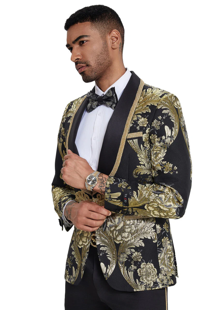 Men's black tuxedo with shiny fabric, gold paisley, and shawl lapel. Tailored fit, satin details. Perfect for formal events.
