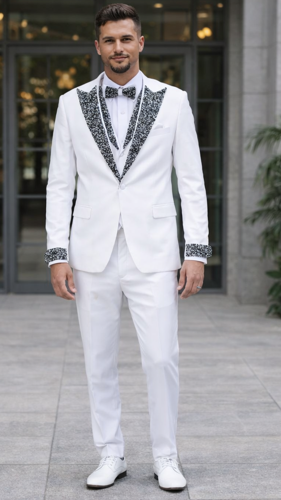 Men's white tuxedo with black stone embellished lapels and cuffs. Features a structured jacket with a notched collar and single-button closure, tailored trousers. Includes white bow tie and dress shoes.
