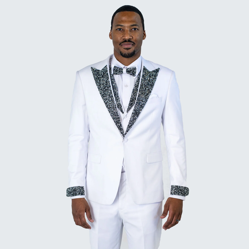 Men's white tuxedo with a fitted single-breasted design. Black sequined shawl lapel and cuffs, matching bow tie. Smooth fabric, clean finish. Includes white dress shirt.
