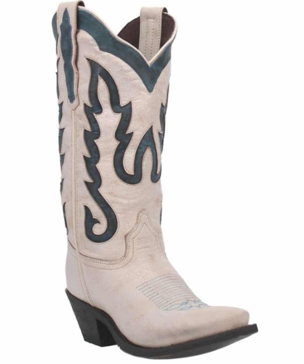 Laredo Women's Keyla Boot: Knee-high, pointed toe, stacked heel. Light beige leather upper with teal accents & Western-style stitching. Flame-like patterns & ribbed toe detail. Brown lined interior.
