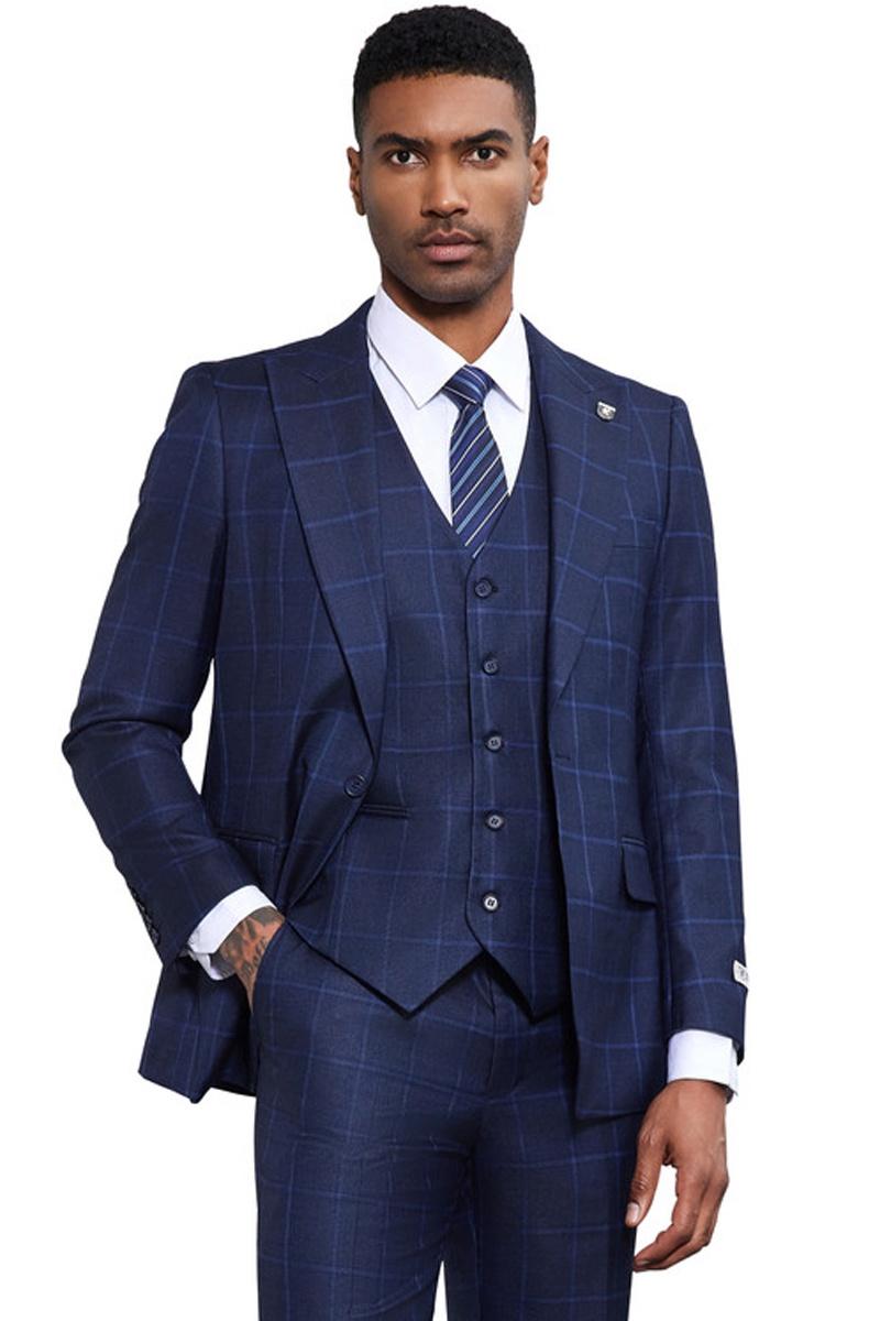 Navy blue Stacy Adams classic suit. One-button jacket, matching five-button vest, and tailored fit. Windowpane pattern with navy and lighter blue. Sharp lapels, structured design.
