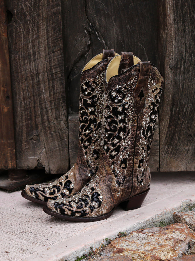 Corral women's black glitter inlay cowboy boots: brown exterior, black floral patterns, silver embellishments. Snip toe design with a structured, lower heel silhouette.
