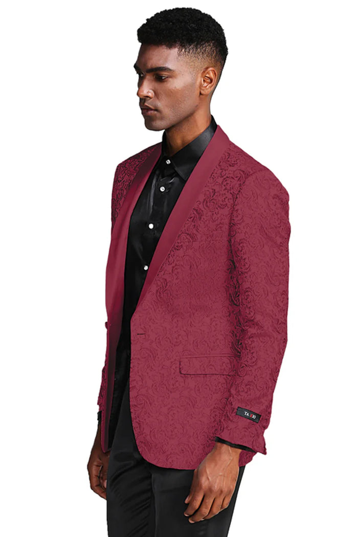 Burgundy paisley slim fit tuxedo jacket. Single-button front, peaked lapels, textured paisley. Smooth, subtly sheened fabric. Two front pockets. Contrasting cuff detail. Tailored appearance.
