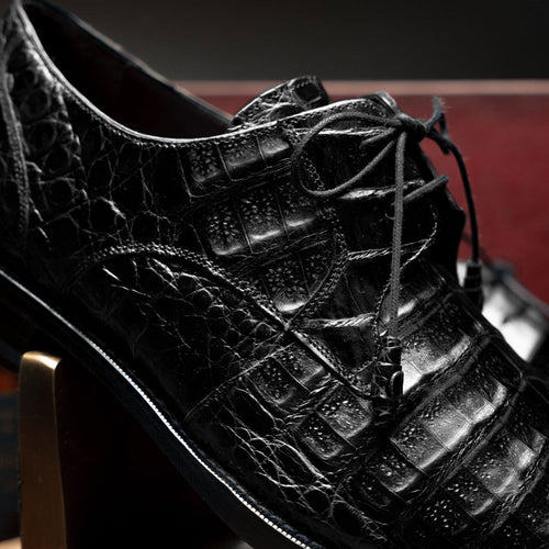 Mezlan Anderson black crocodile derby shoes. Structured lace-up design with a smooth finish and a distinct crocodile texture featuring raised scales.
