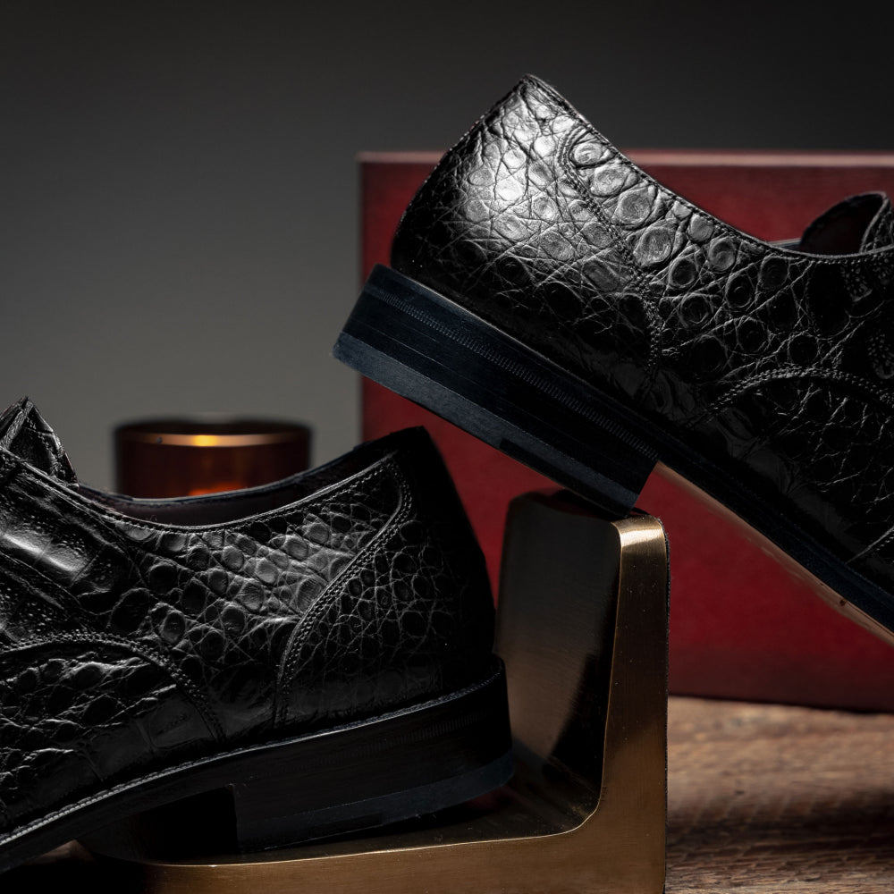 Mezlan Anderson black derby shoes. Crocodile-textured leather, rounded toe, and flat sole. Subtle stitching detail. A stylish, sturdy choice.
