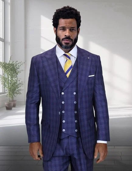The Statement men's 3-piece big and tall suit features a tailored fit with a dark blue check pattern, including a jacket, vest, and trousers. The jacket has notch lapels and two front pockets, while the vest displays five buttons. The trousers have a straight leg cut.