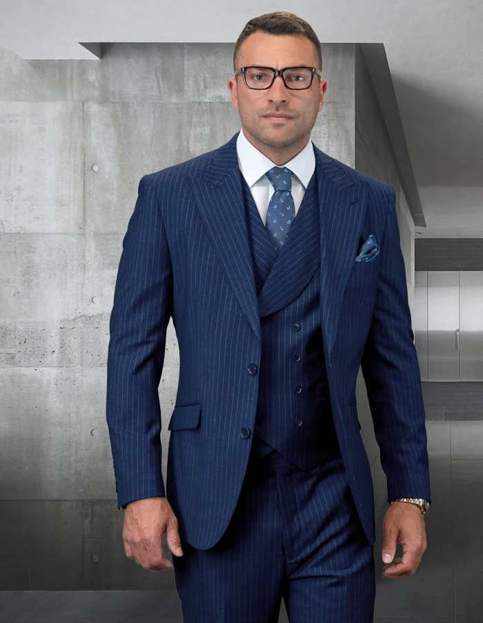 Men's grey gangster-style suit. Double-breasted vest with narrow pinstripes and smooth texture. Features shawl collar and button closures. Streamlined silhouette.
