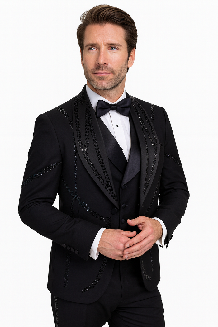 Black Italian wool tuxedo. Modern fit, three-piece: jacket with embellishments, single-breasted shirt, trousers. Classic shawl collar, sleek design.
