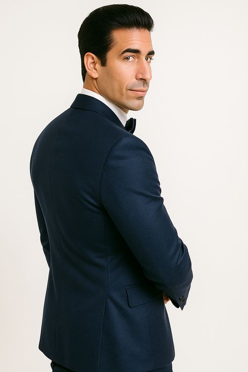 Alberto Nardoni's blue tuxedo: fitted jacket with structured shoulders, tapered waist, single-button closure, and standard lapels. Includes black bow tie. Features side pockets and contrasting lining. Deep blue hue, sophisticated design.
