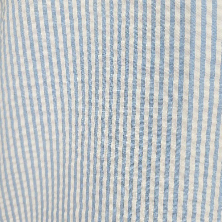 Blue seersucker 2pc set by Alberto Nardoni. Light blue and white striped, textured fabric. Lightweight with a crinkled seersucker surface.