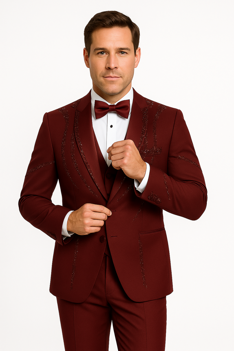 Burgundy Italian wool 3-piece tuxedo by Alberto Nardoni. Fitted silhouette with structured jacket, trousers, and waistcoat. Features include subtle sheen, patterned embellishments, notch lapel. Perfect formal wear.