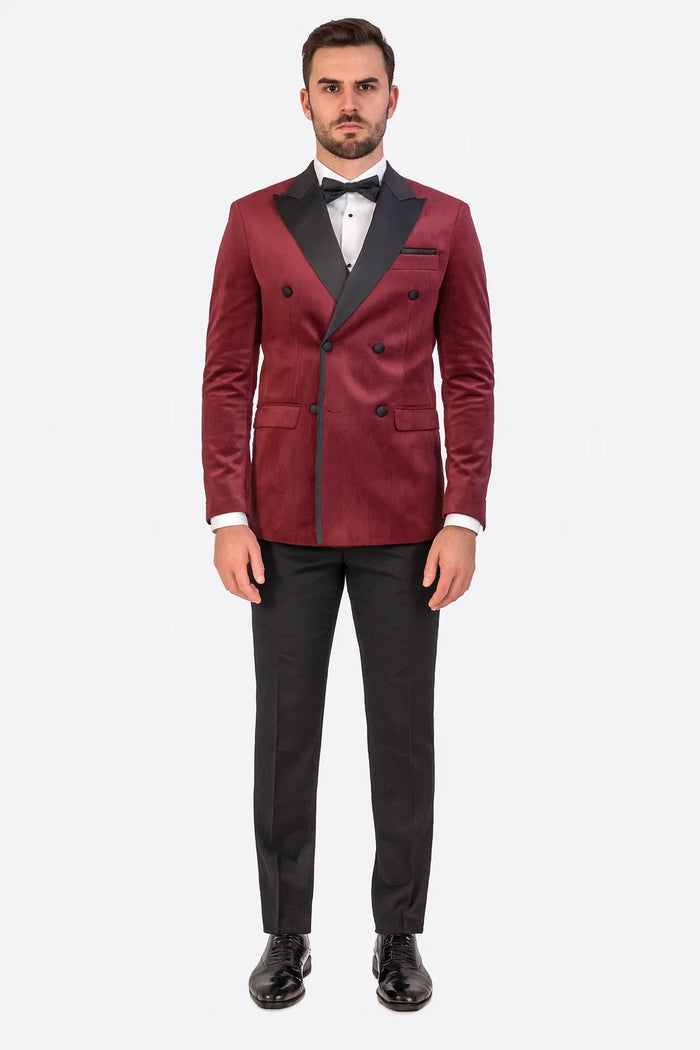 Burgundy velvet double-breasted tuxedo jacket. Black peaked lapels, six front buttons, and dual side pockets. Rich, textured fabric.

