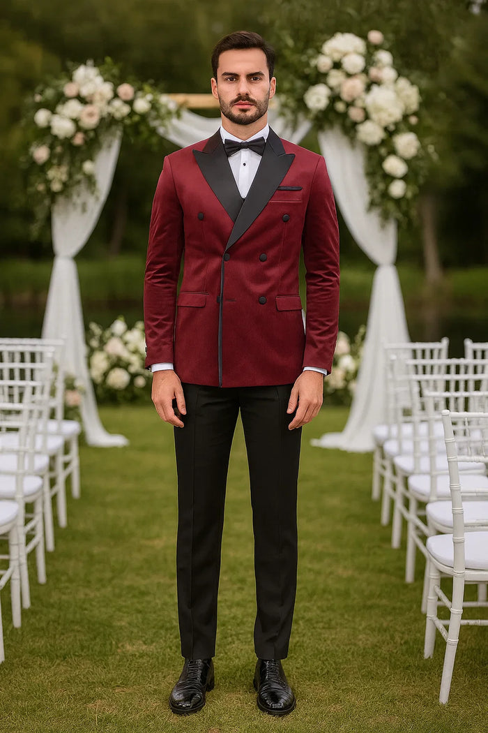 Burgundy velvet double-breasted tuxedo jacket. Structured silhouette, peaked satin lapels, and black satin accents. Tailored fit enhances the formal look. Rich burgundy color.

