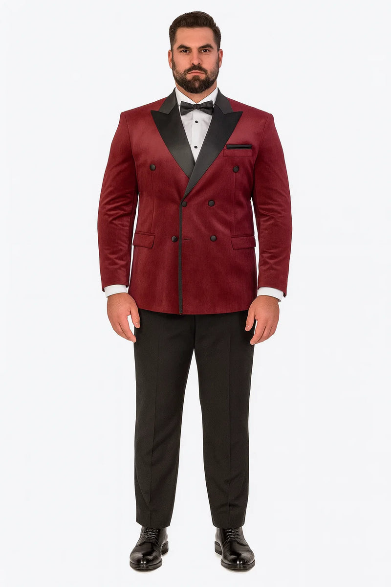 Burgundy velvet double-breasted tuxedo jacket. Tailored silhouette, sleek lapels, dual button rows, and side pockets. Features black lapel accents, enhancing its formal style.
