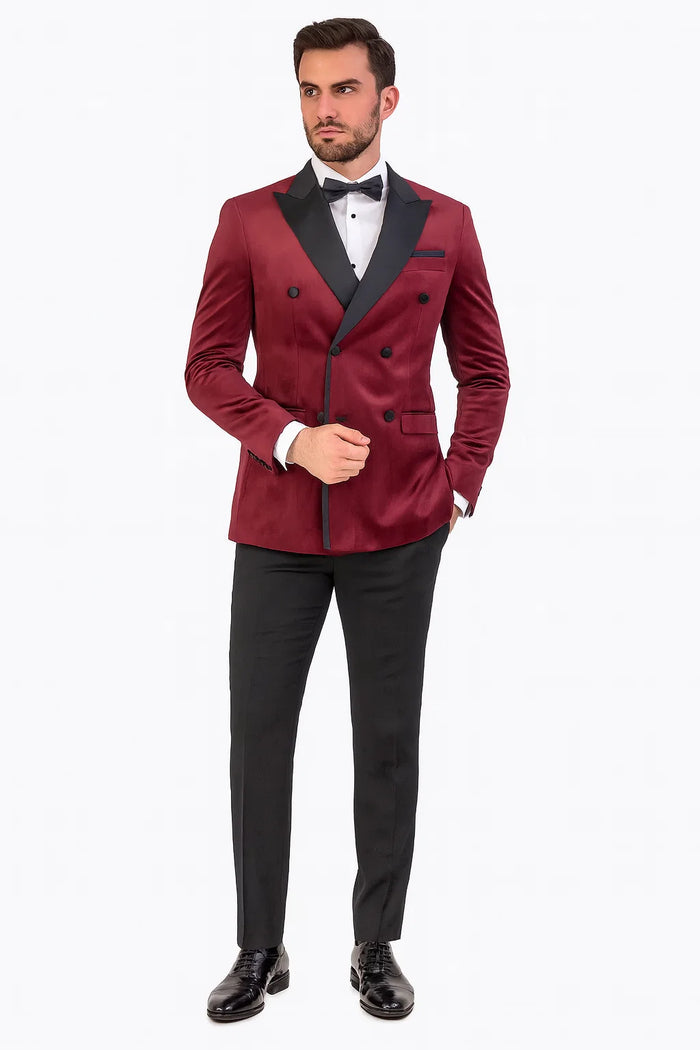 Burgundy velvet double-breasted tuxedo jacket. Classic design: peaked lapels, double-row buttons, side pockets. Smooth, textured fabric.
