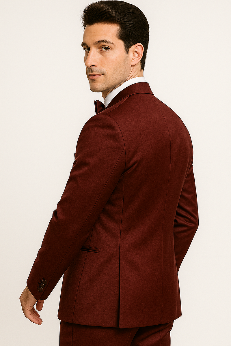 Burgundy Majesty tuxedo: Tailored jacket with structured silhouette, notch lapel, and single-breasted design. Rich burgundy color for a formal look, complemented by a matching bow tie.
