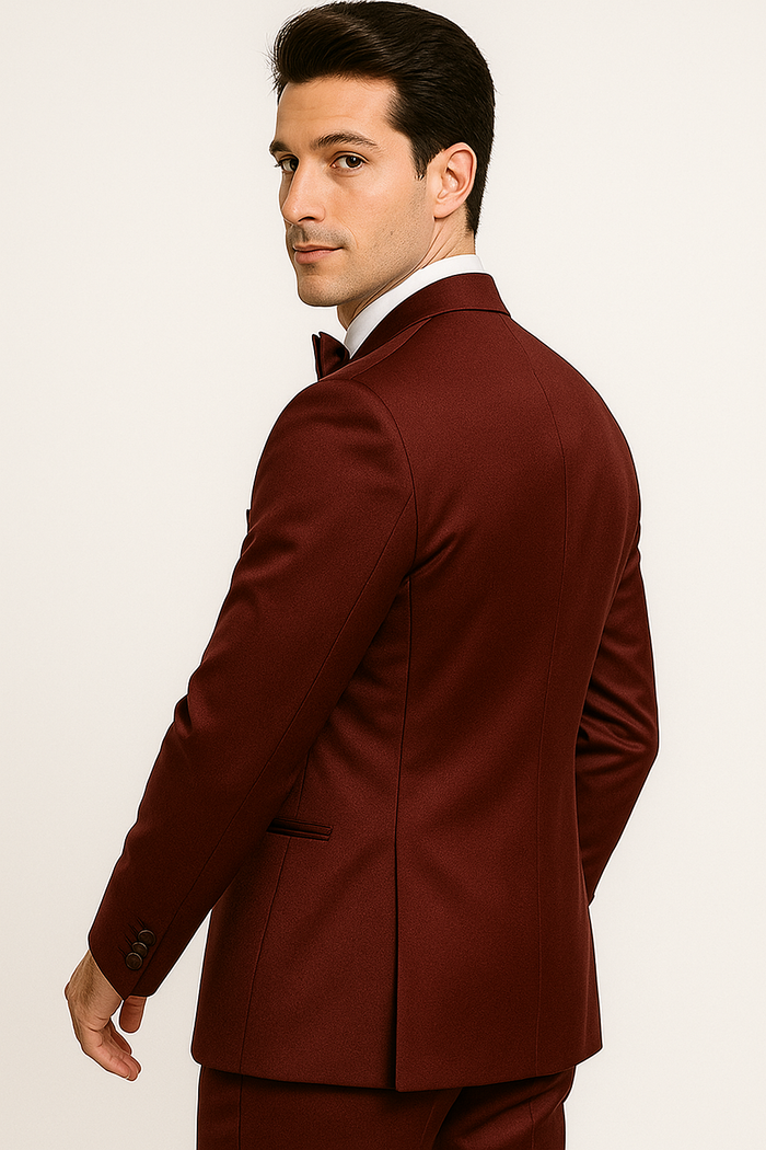 Burgundy Majesty tuxedo: Tailored jacket with structured silhouette, notch lapel, and single-breasted design. Rich burgundy color for a formal look, complemented by a matching bow tie.
