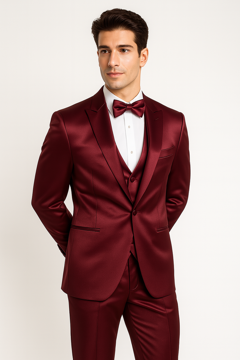 Burgundy Majesty tuxedo: fitted jacket (satin, 2-button), matching pants, vest, and bow tie. Tailored silhouette, notch lapels, V-neck vest, and sleek trousers for a formal, cohesive look.