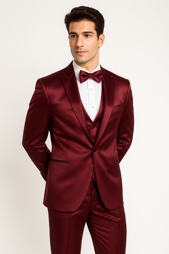 Burgundy Majesty tuxedo: fitted jacket (satin, 2-button), matching pants, vest, and bow tie. Tailored silhouette, notch lapels, V-neck vest, and sleek trousers for a formal, cohesive look.