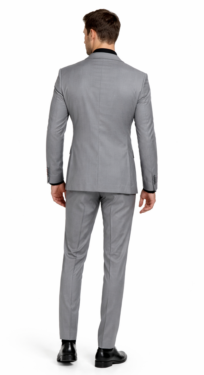 Carlo Lusso medium gray two-button poly blend suit. Tailored fit, solid pattern, structured shoulders. Tapered trousers. Classic two-button closure. Black collar/cuff detailing & contrasting sleeve buttons.
