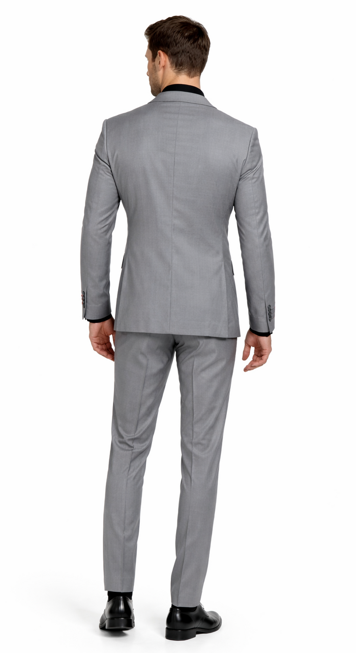 Carlo Lusso medium gray two-button poly blend suit. Tailored fit, solid pattern, structured shoulders. Tapered trousers. Classic two-button closure. Black collar/cuff detailing & contrasting sleeve buttons.
