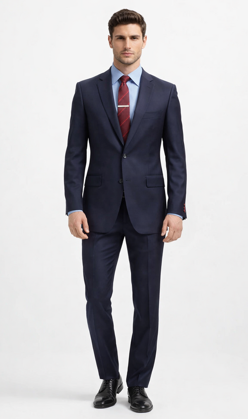 Carlo Lusso navy suit: tailored fit, poly blend. Includes a two-button blazer with notched lapel, two pockets, and a single vent. Straight-leg trousers. Classic design, solid navy.
