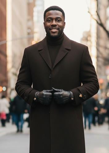 Men's brown single-breasted top coat with structured collar, button closure, and long sleeves. Made from dense fabric with a smooth finish.
