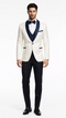 Modern 3-piece tuxedo: white patterned jacket with navy lapel & trim, black tailored trousers, and matching bow tie.