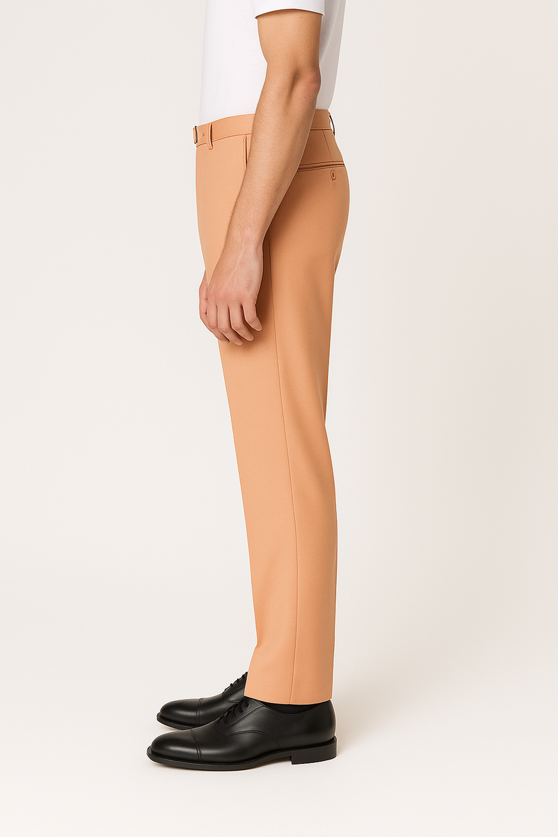 Tiglio Luxe Marbella dress pants. Semi-wide leg, smooth silhouette in soft peach-orange wool. Visible waistband with belt loops. Paired with black dress shoes.
