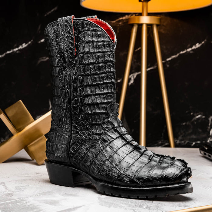 Marco Di Milano Marlboro cowboy boots in black hornback crocodile. Tall shaft, pointed toe, & textured leather. Red lining, black tractor sole, low heel, and pull tabs.
