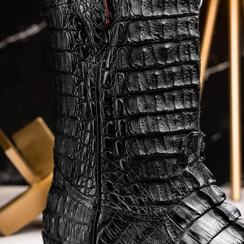 Marco Di Milano Marlboro Black cowboy boots. Black hornback crocodile tail leather. Tractor sole. Pointed toe, structured shaft, and side zipper. Rugged construction with distinctive raised scales.

