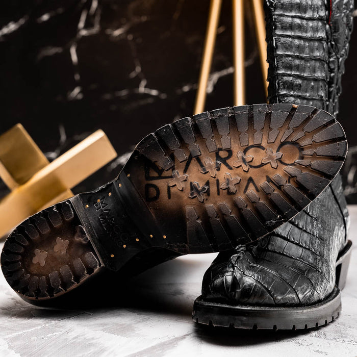 Marco di Milano Marlboro Black cowboy boots. Black hornback crocodile tail upper. Tractor sole for traction. Sleek silhouette with rounded toe. Visible stitching adds detail.
