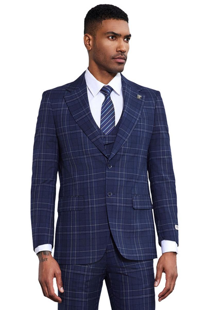 Navy Stacy Adams suit with double windowpane plaid. Fitted, two-button closure, shawl lapel. Includes matching vest, front pockets, and button cuffs. Modern, classic tailoring.

