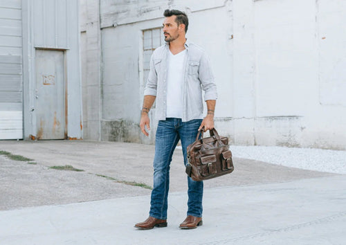 Dan Post Kingly boots: Black, genuine caiman belly leather. Square toe design with distinct textures. Low heel, pointed foot shape for a structured look.

