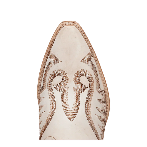 Dan Post Josie boots: Women's tall leather boots with a snip toe. Intricate brown stitching on white leather, highlighting an elongated silhouette.

