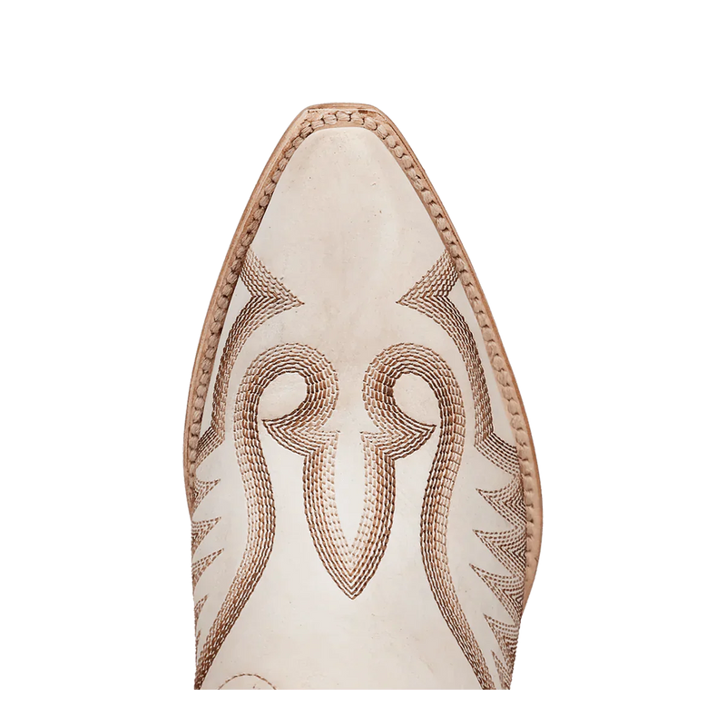Dan Post Josie boots: Women's tall leather boots with a snip toe. Intricate brown stitching on white leather, highlighting an elongated silhouette.
