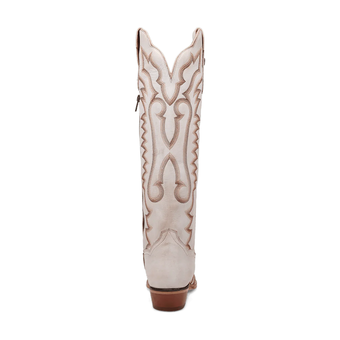 White Dan Post Josie boots. Tall shaft, snip toe, and small heel. Decorative tan stitching in swirling side pattern. Crafted from smooth leather.
