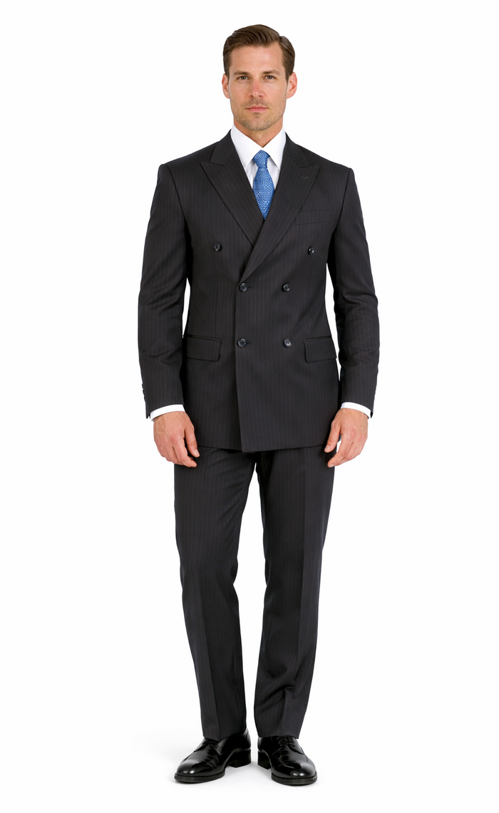 Dark navy double-breasted suit with subtle pinstripes. Tailored fit, notched lapels, four-button front. Straight-cut trousers. Smooth, structured fabric.
