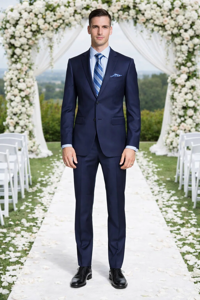 Enzo 150 S Super Wool suit in dark navy. Slim fit, 2-button, single-breasted, notch lapels. Features a subtle sheen. Includes two front pockets, a chest pocket, and matching tailored pants.