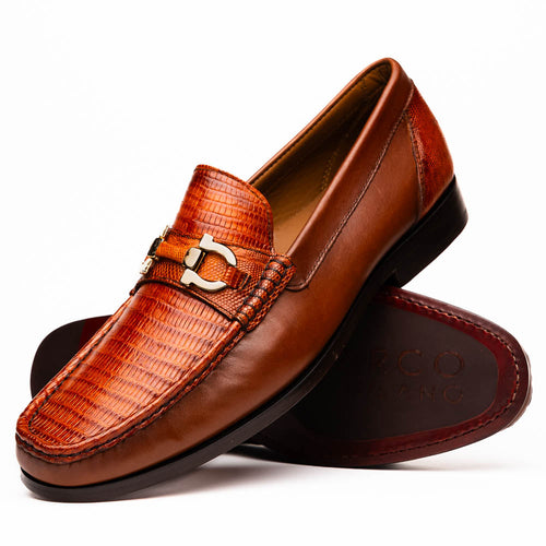 Marco Di Milano Enzo loafers. Cognac lizard upper, gold bit detail. Moccasin-style with rounded toe. Black tapered sole, red underside. Sleek, polished design.
