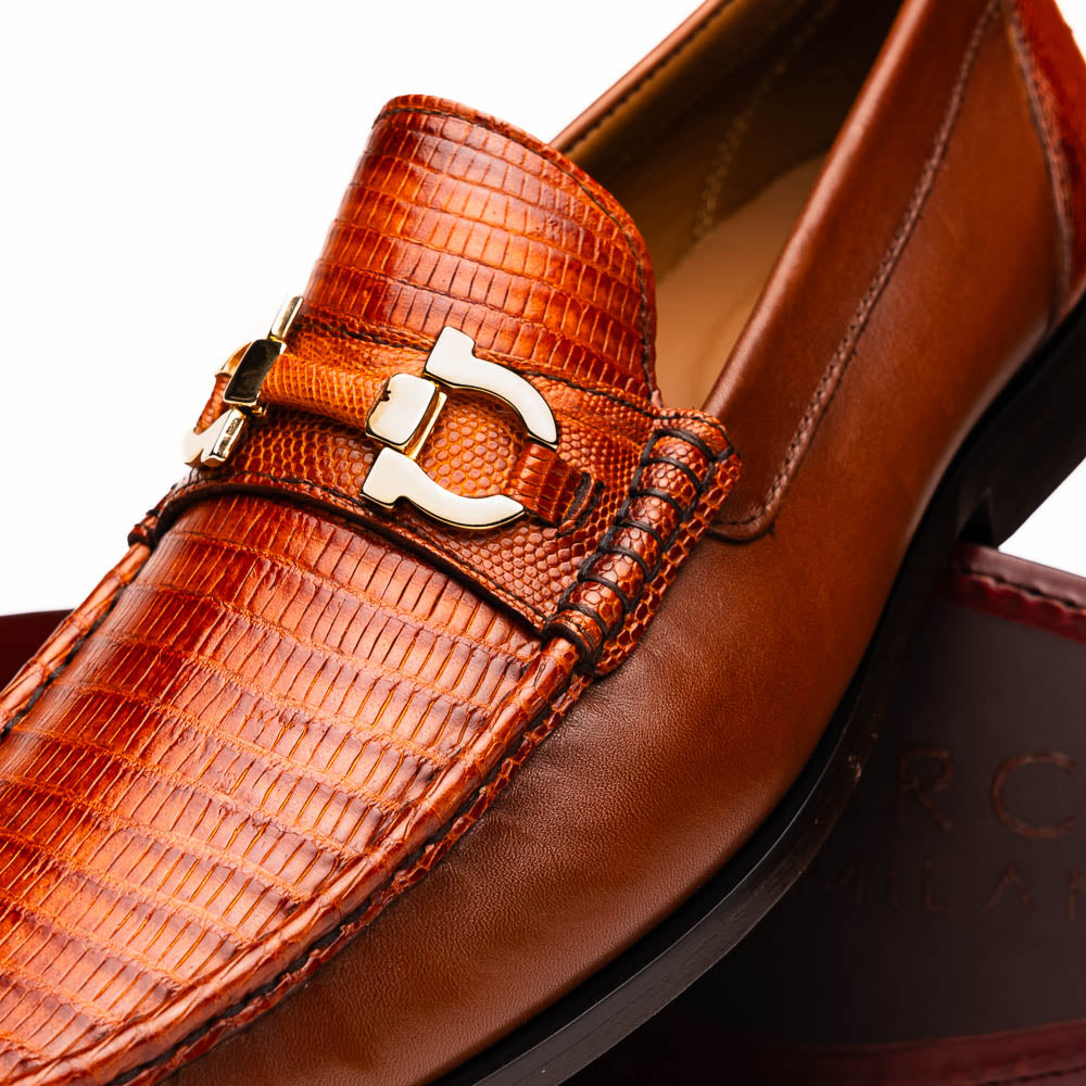 Marco Di Milano Enzo loafers in cognac lizard. Rounded toe, low-cut upper, and textured pattern. Gold bit accent at front, leather lining, and black sole for contrast.
