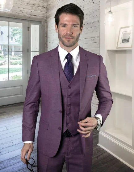 This men's 3-piece fashion suit features a subtle texture, crafted from 100% wool. The suit is predominantly purple, including a matching vest and pants, with a white dress shirt and a patterned dark tie. The design includes a single-breasted jacket with notch lapels and a pocket square.