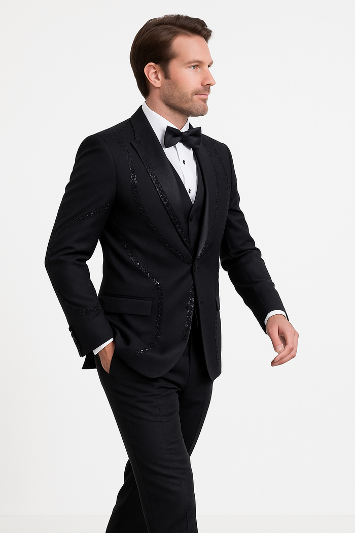 Modern-fit black three-piece tuxedo. Structured silhouette with satin lapel and sequined accents on the jacket. Black vest. Tailored trousers match the jacket. Cohesive, elegant look.
