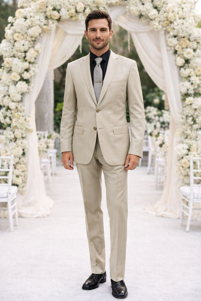 Albertonardoni's "Galante Uomo" beige suit: fitted, two-button, single-breasted jacket with notched lapels and pockets. Flat-front trousers. Smooth fabric with subtle pattern. Styled with black shirt & patterned tie.
